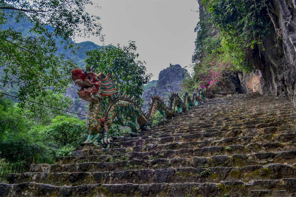 Climbing Dragon Mountain Ninh Binh begins with nearly 500 stone steps winding steeply along the mountainside 